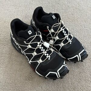Black and white Salomon’s shoes.